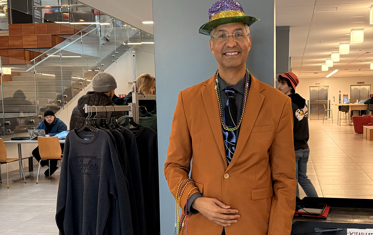 Provost Lorenzo Smith decked out and handing out beads to incoming party guests.