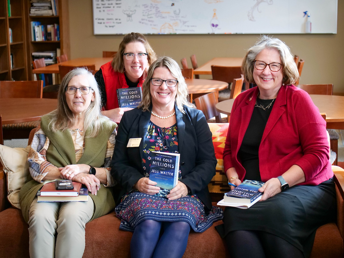 Four faculty and staff at the book reading.