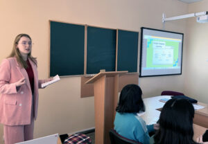 Valeriia Sichka standing in a classroom teaching.