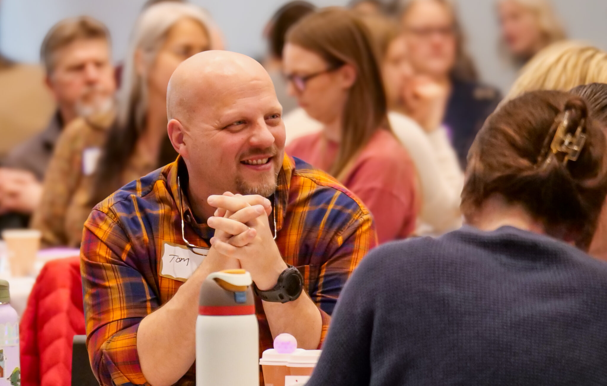 Employees talking at the tables.