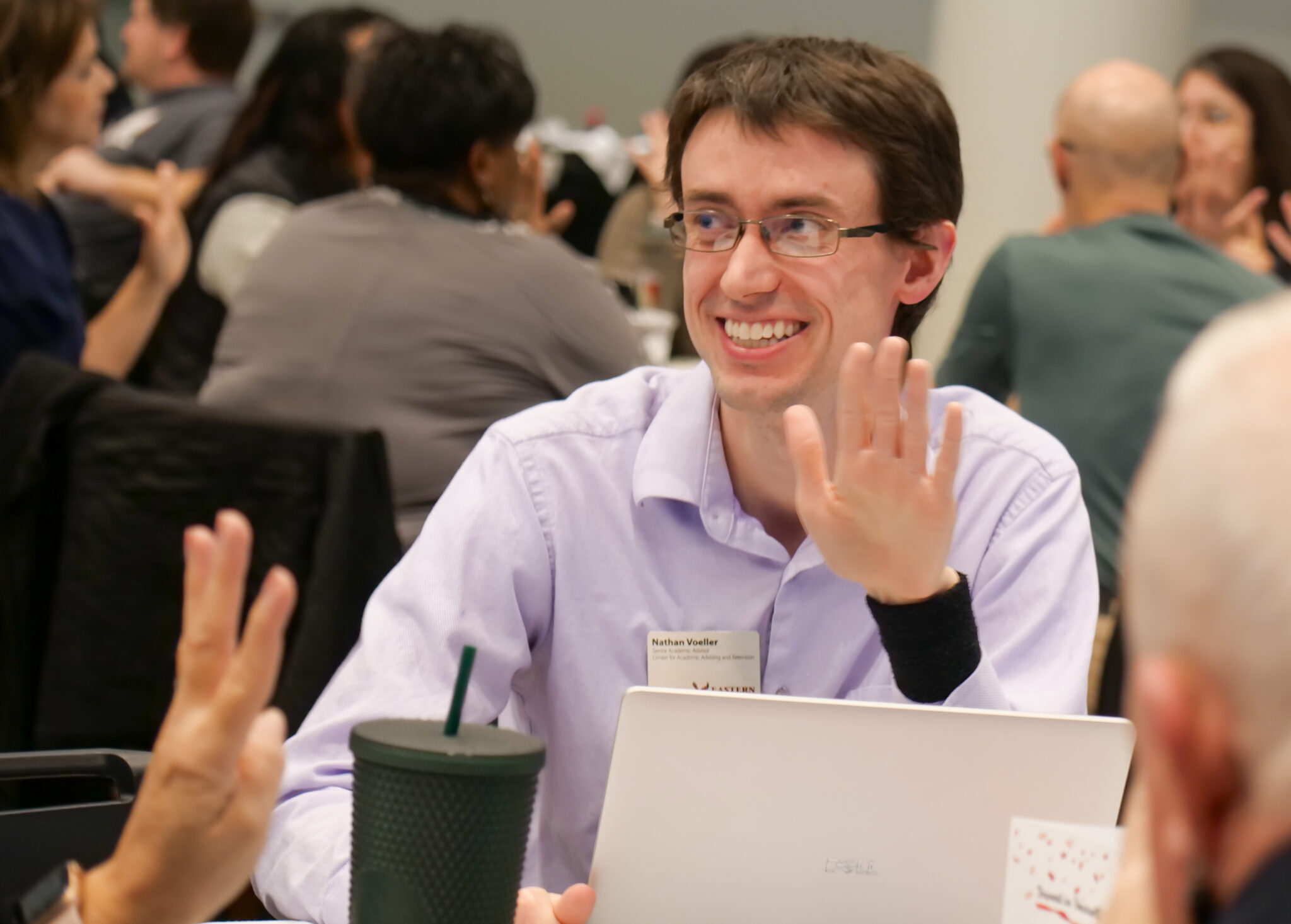 Employee smiling while playing the five-finger game.