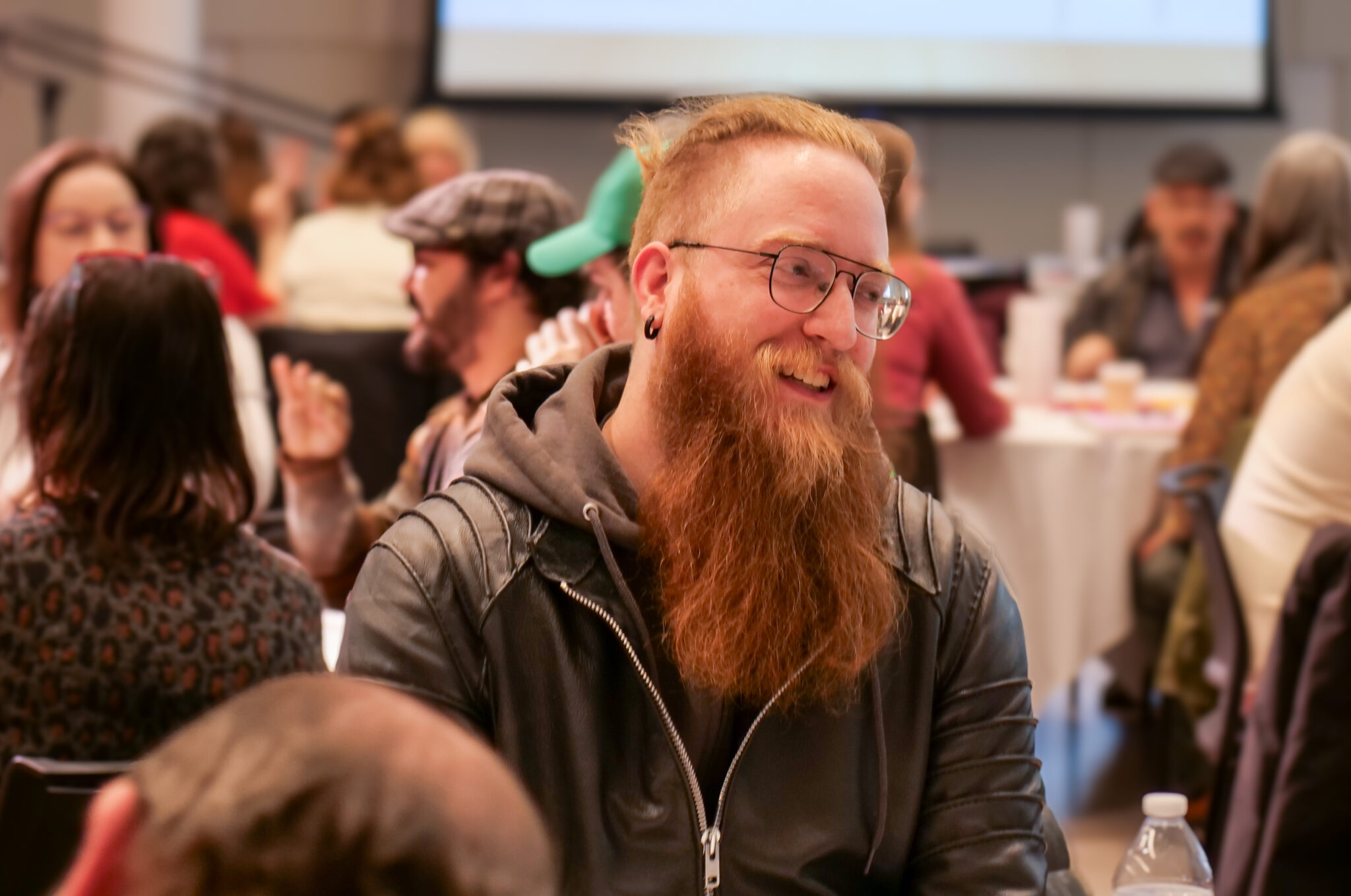 Employee with a long beard smiling.