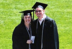 Tessa and John in their caps and gowns at commencement.