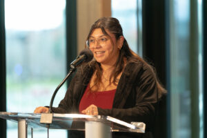 ASEWU President Kira Urbina speaking at the podium.