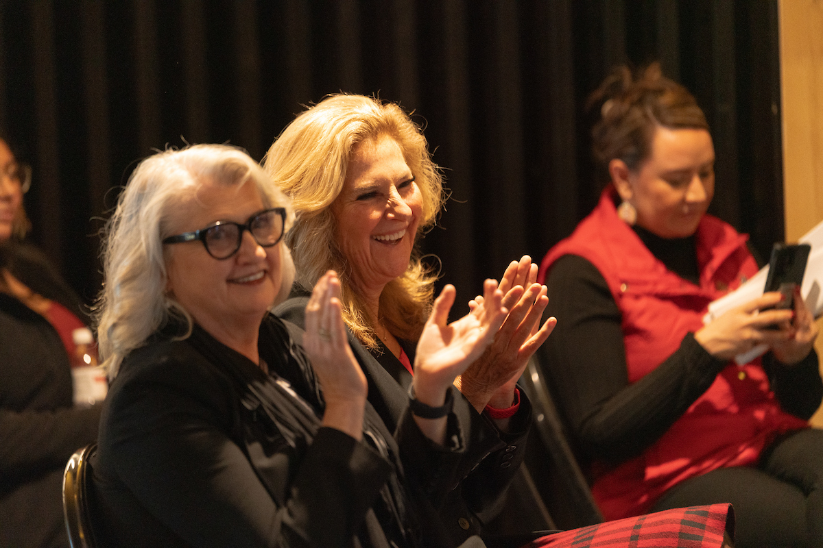 President and group clapping.