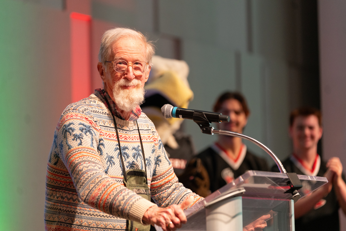 Bill Youngs at the podium smiling.