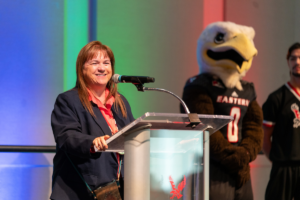 Margo Hill at the podium smiling.