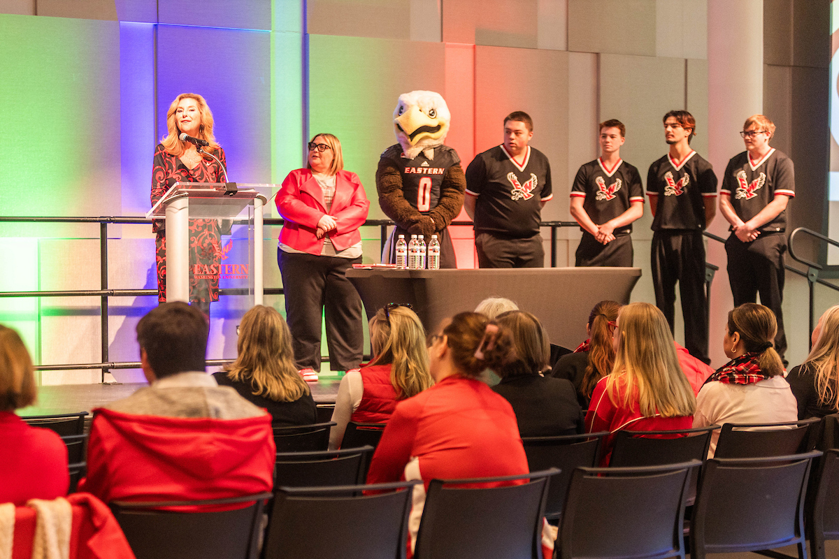 President McMahan speaking at the podium with others on stage.