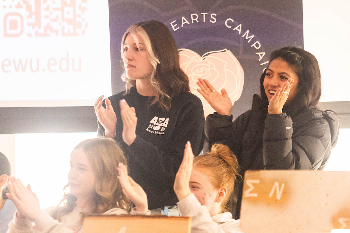 Two sorority members clapping.
