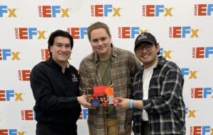 The three engineering students with their robot.