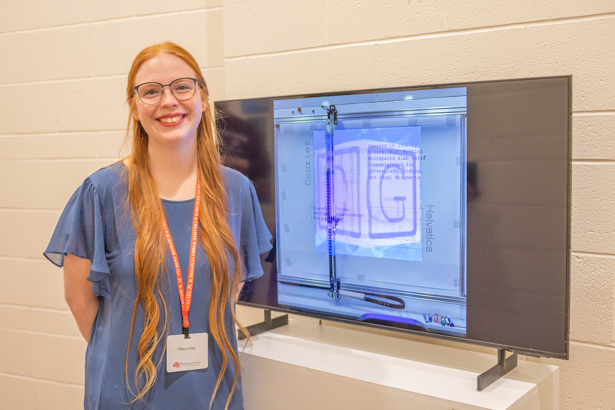 Student posing with her art