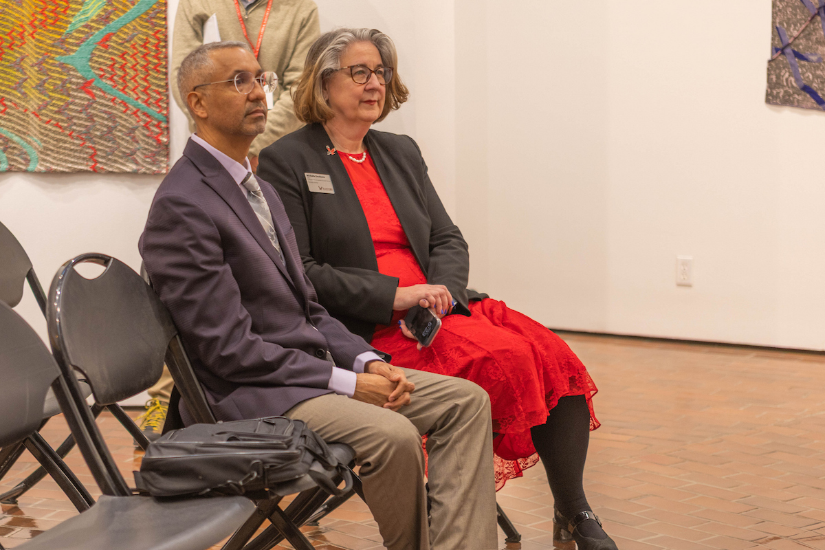 Provost Lorenzo Smith and Michelle DenBeste, Dean of CAHSS, watching a music performance in the gallery.
