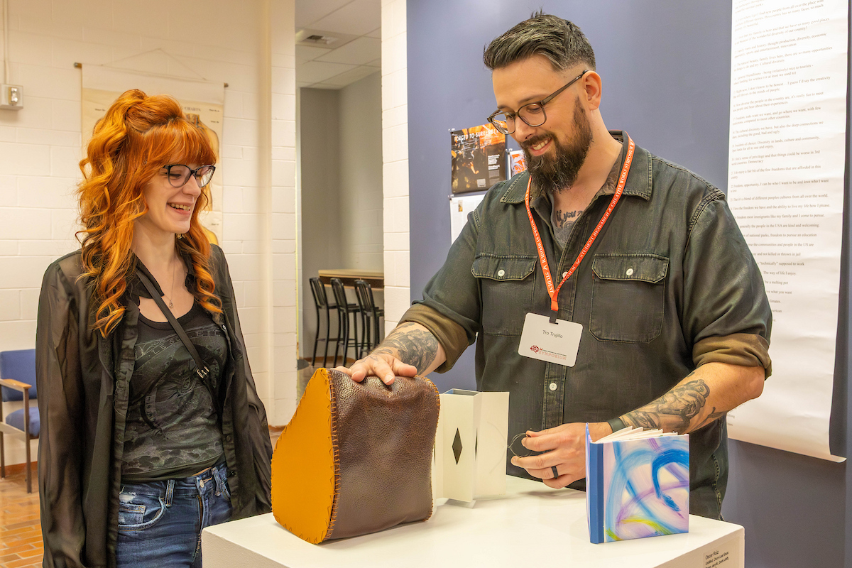 Student with faculty member ad interactive art