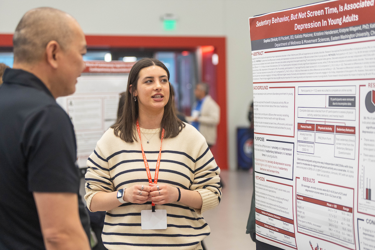 Student explaining presentation to someone