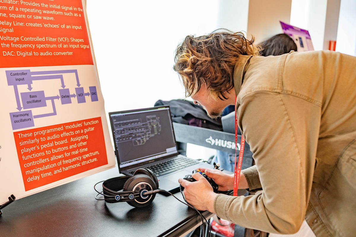 Student leaning over computer