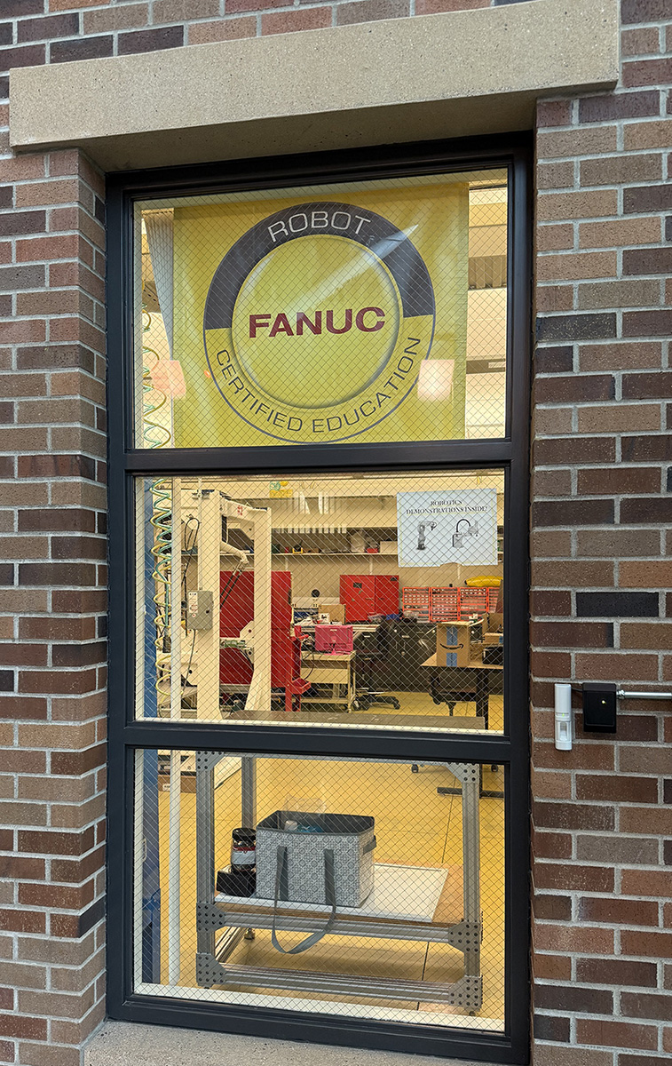 FANUC banner in the window of the robotics lab.